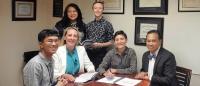 Six healthcare professionals sitting in an corner office space